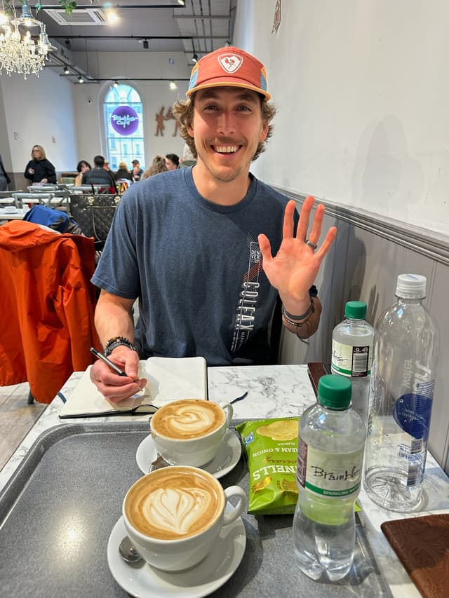 Waving at my wife, exhausted, in a Dublin cafe.